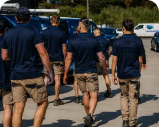 Plumbers walking to their service vans on a Airds job